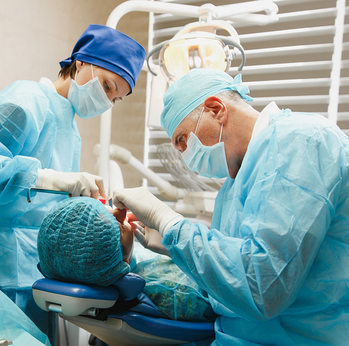 Dentists performing treatment on patient