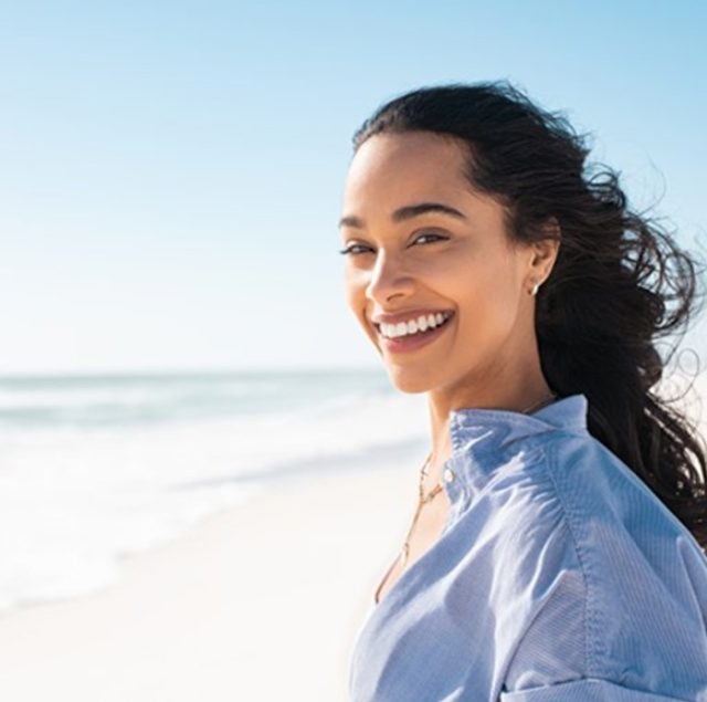 woman smiling at the beach
