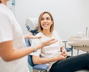 Patient smiling during consultation at Kimberly Lane Family and Cosmetic Dentistry, discussing porcelain veneers with a dental professional.